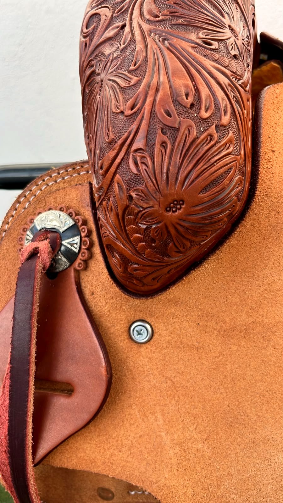 Floral hand-tooling detail with silver concho